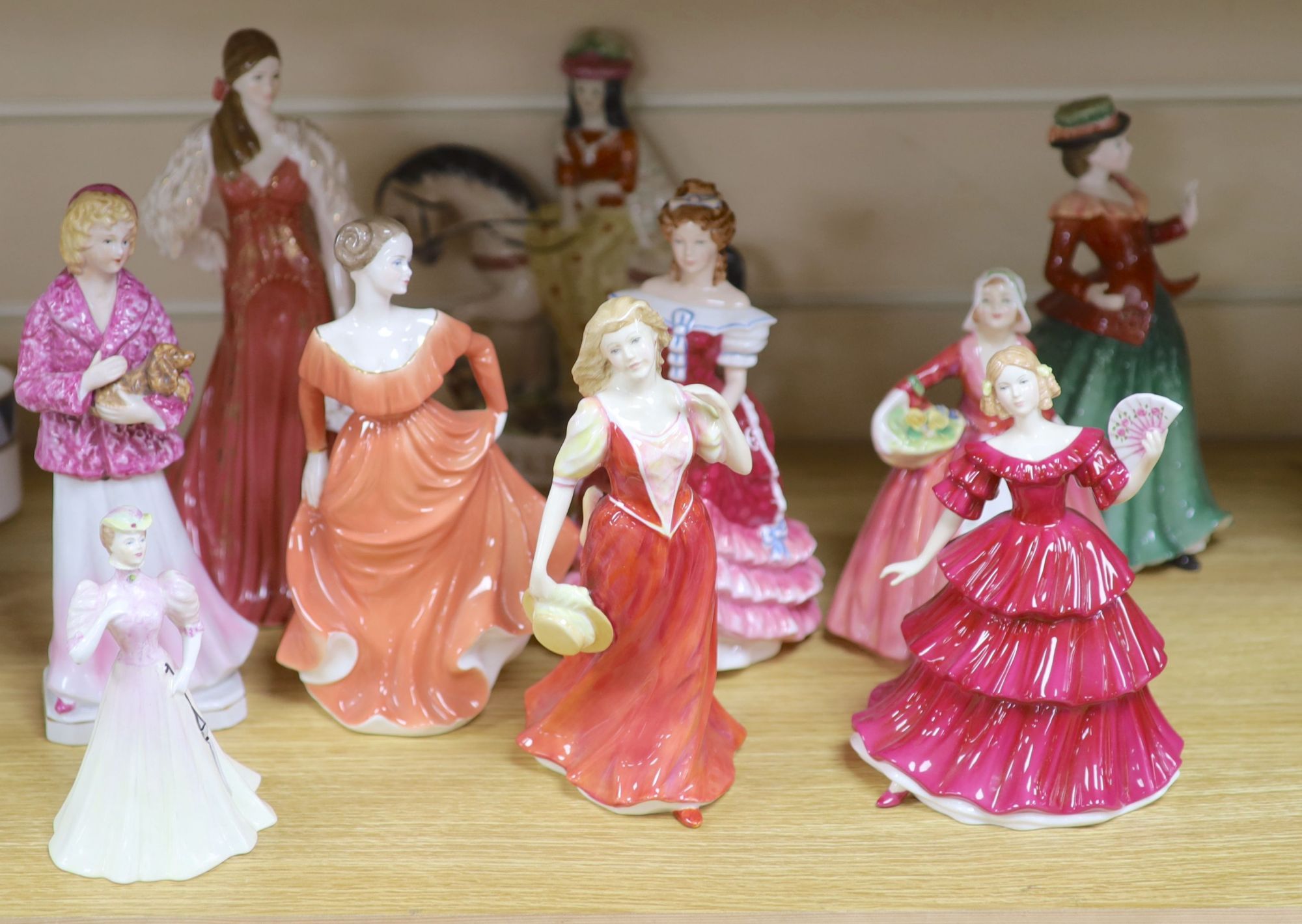 Five Royal Doulton porcelain ladies, two Coalport, one Worcester, another porcelain lady and a Staffordshire figure